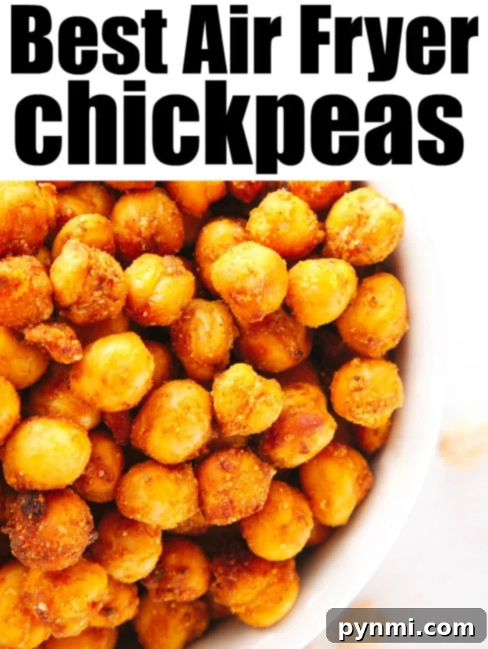 Air fryer chickpeas are crispy high protein snacks with tons of flavor. Tossed in taco seasoning they cook in no time. You'll love bringing these on the go. #airfryerchickpeas #chickpeas #airfryer #airfryerrecipes #ninjafoodi A vibrant bowl of crispy Air Fryer Chickpeas, garnished and ready to be enjoyed as a healthy snack or topping.