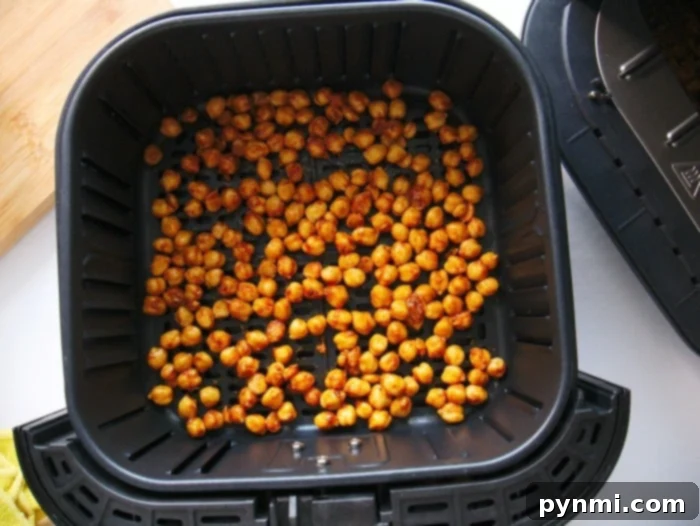 Ultimate Air Fryer Chickpea Crunch 5 A bowl of oiled and seasoned chickpeas ready to be air-fried.