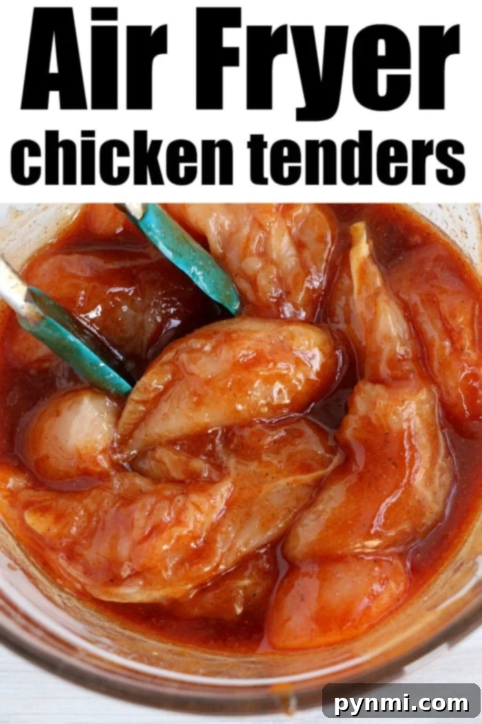 Raw chicken tenders marinating in a rich barbecue sauce, prepared for air frying without breading, symbolizing a healthy meal.