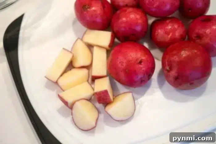 Diced red potatoes on a cutting board, ready for seasoning and air frying.