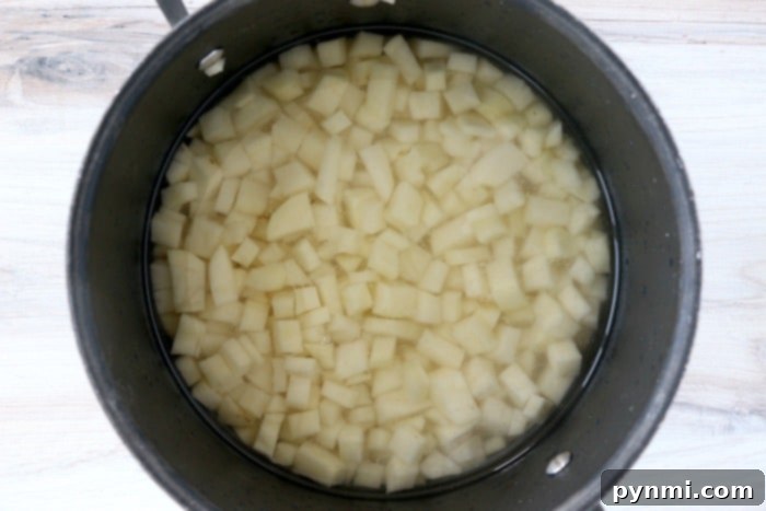 Close-up of freshly diced russet potatoes, ready for boiling.
