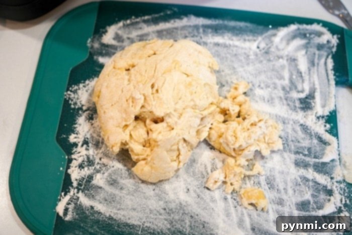 Golden Air-Fried Tortillas 7 Preparing flour tortilla dough on a wooden surface, showing its smooth texture before shaping and cooking.