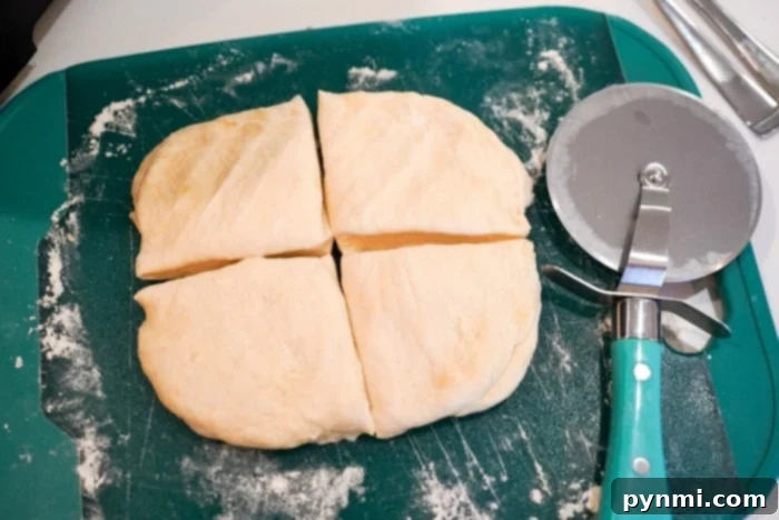 Golden Air-Fried Tortillas 8 Homemade flour tortilla recipe in its simplicity, with dough cut into four pieces on a vibrant green cutting board, and a pizza cutter resting beside it, ready for shaping.