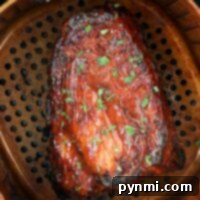 Air Fried Pork Rib Perfection 5 Succulent ribs glazed with herbs are perfectly cooked in a Ninja air fryer, then placed in a perforated pan.