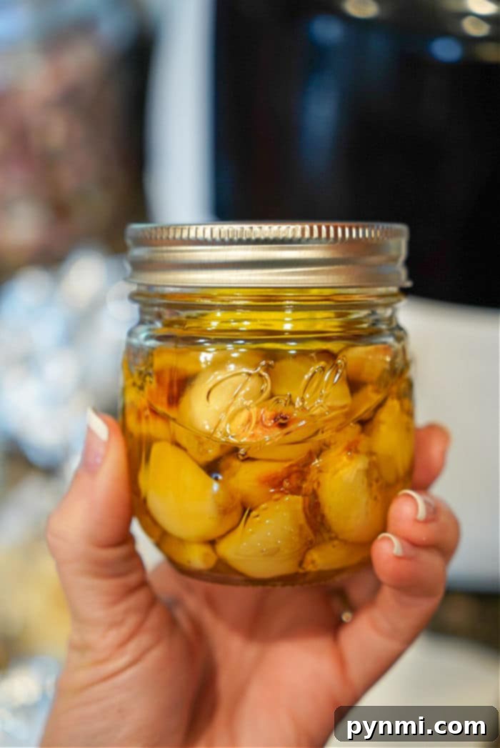 How to Mince Garlic from Whole Cloves 5 A hand holds a jar of garlic cloves, ready to transform into any dish. Perfect for those who appreciate the ease of cloves to minced garlic conversion in their culinary adventures.