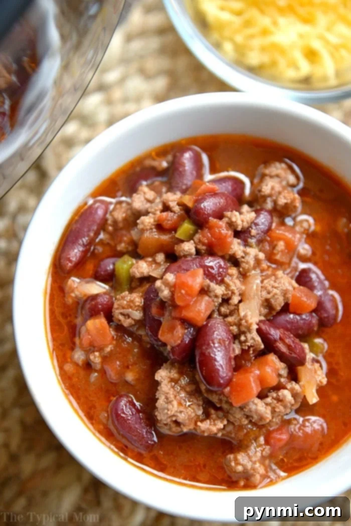 Less Is More Meals 8 A hearty bowl of Instant Pot chili, garnished with shredded cheese and green onions, showcasing the rich colors and textures of this simple 5-ingredient recipe. It's a comforting and easy meal solution.