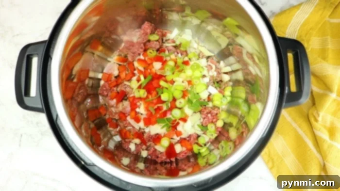 Effortless Instant Pot Ground Beef and Rice Dinner 4 Instant Pot dirty rice ingredients laid out on a kitchen counter
