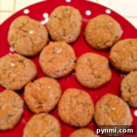 Lebkuchen cookies on a red polka-dot plate, drizzled with honey.