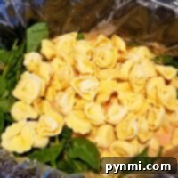 Comforting Crockpot Tortellini Soup 6 Crockpot tortellini soup with fresh spinach and sauce offers a delightful combination of flavors, slowly cooked to perfection.