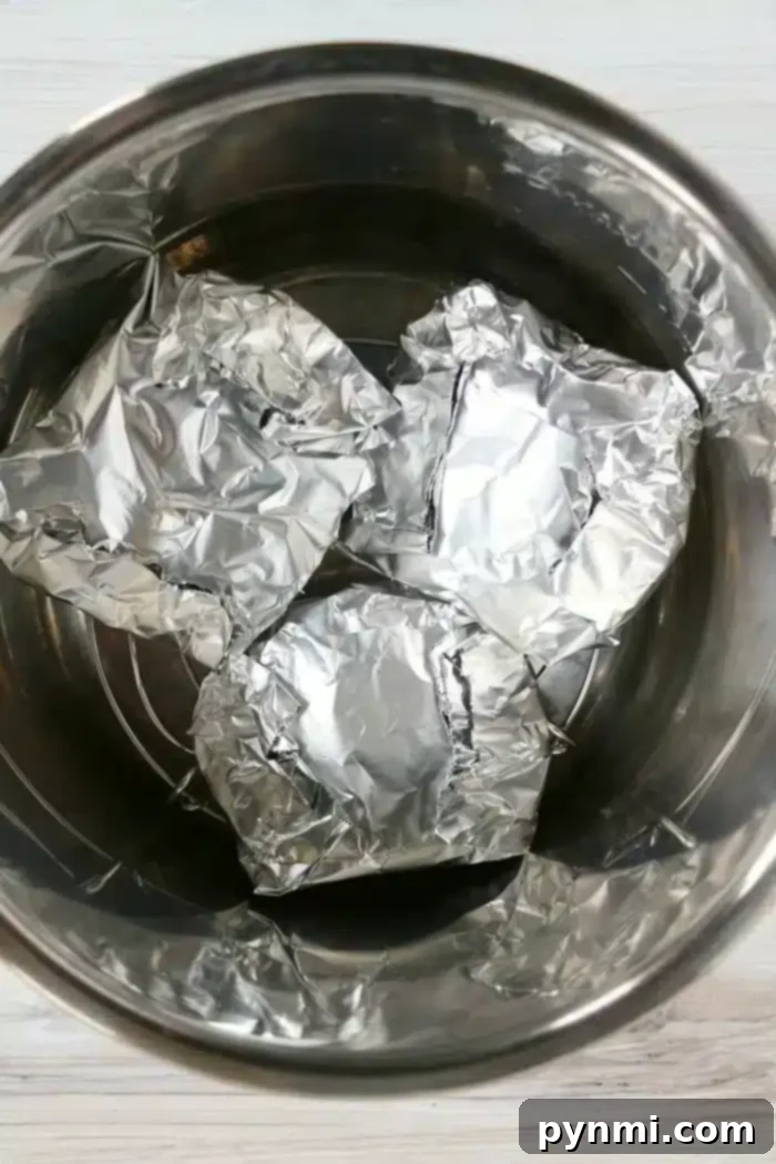 A stack of cooked frozen hamburgers from the Instant Pot, ready for toppings.
