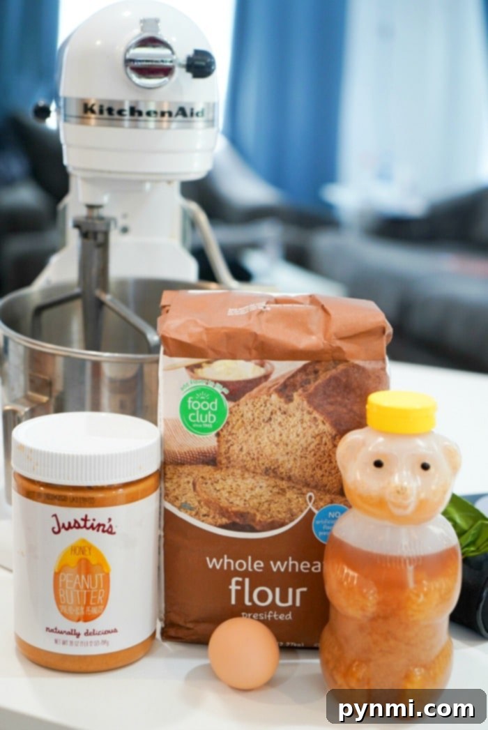 Peanut Butter dog biscuits made with honey that your puppy will love! Just 5 ingredients and under 30 minutes. Close-up of freshly baked homemade peanut butter dog treats on a cooling rack