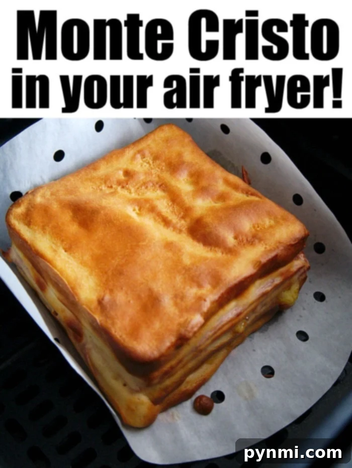 Air fryer Monte Cristo sandwich is a bite of heavenly perfection. If you love the ham and Swiss battered version at Disneyland, you'll go crazy over this A sliced air fryer Monte Cristo sandwich revealing layers of ham and cheese, ready for dipping.