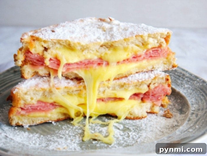 Golden Air Fryer Monte Cristo 5 Multiple Monte Cristo sandwiches served on a plate with fresh fruit and powdered sugar.