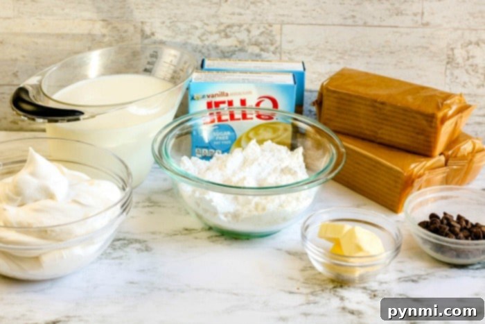 Layers of creamy pudding being spread over graham crackers for a no-bake cake.