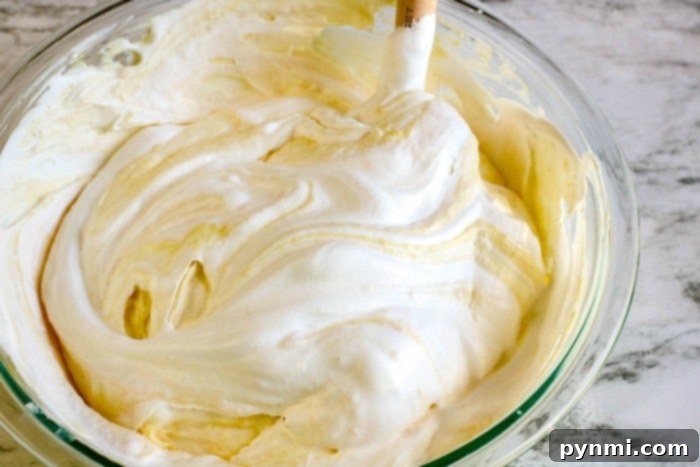 Mixing instant pudding with milk for a creamy no-bake cake filling.