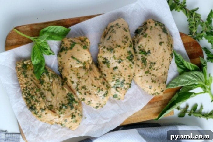 Zesty Lemon Pepper Chicken Marinade 5 Close-up of a homemade herb chicken marinade in a bowl, showing fresh ingredients like lemon slices and green herbs, ready to tenderize and flavor poultry.