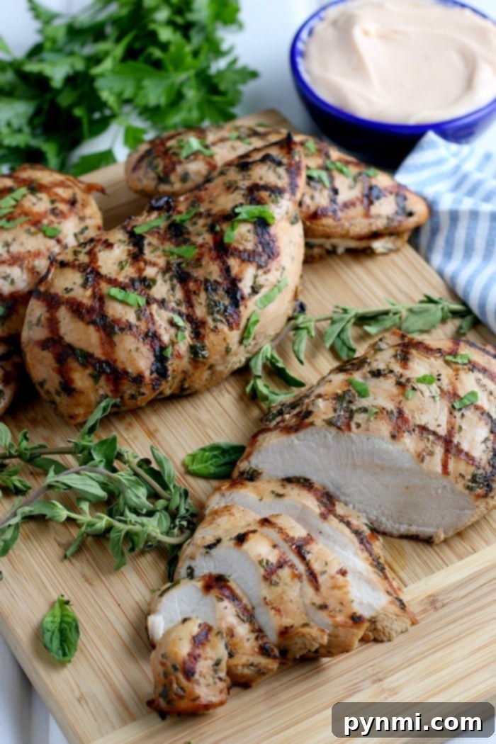 Zesty Lemon Pepper Chicken Marinade 8 Grilled lemon pepper chicken marinade served on a wooden board, garnished with fresh herbs and lemon slices, highlighting its vibrant flavor and tenderness. Perfect for a healthy meal.