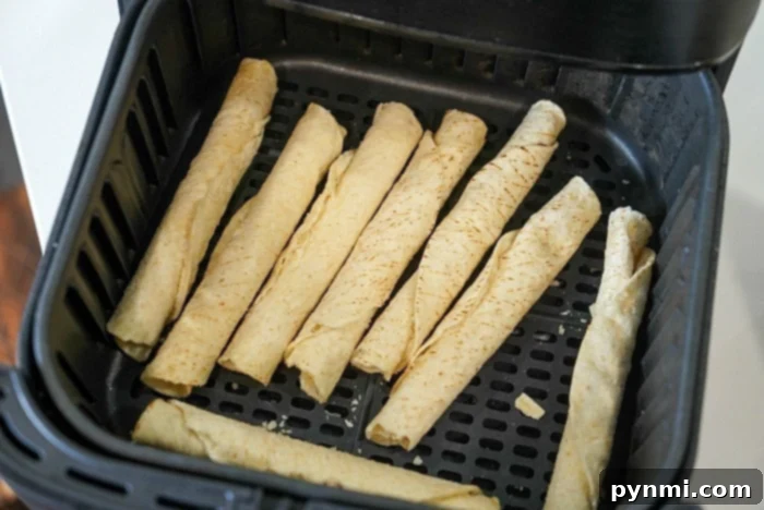 Close-up of several crispy frozen taquitos, showcasing their golden texture. Ideal for air frying to achieve maximum crunch and flavor.