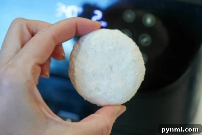 Perfect Air Fryer Frozen Biscuits 4 A basket full of golden-brown air fryer frozen biscuits, ready to be served.
