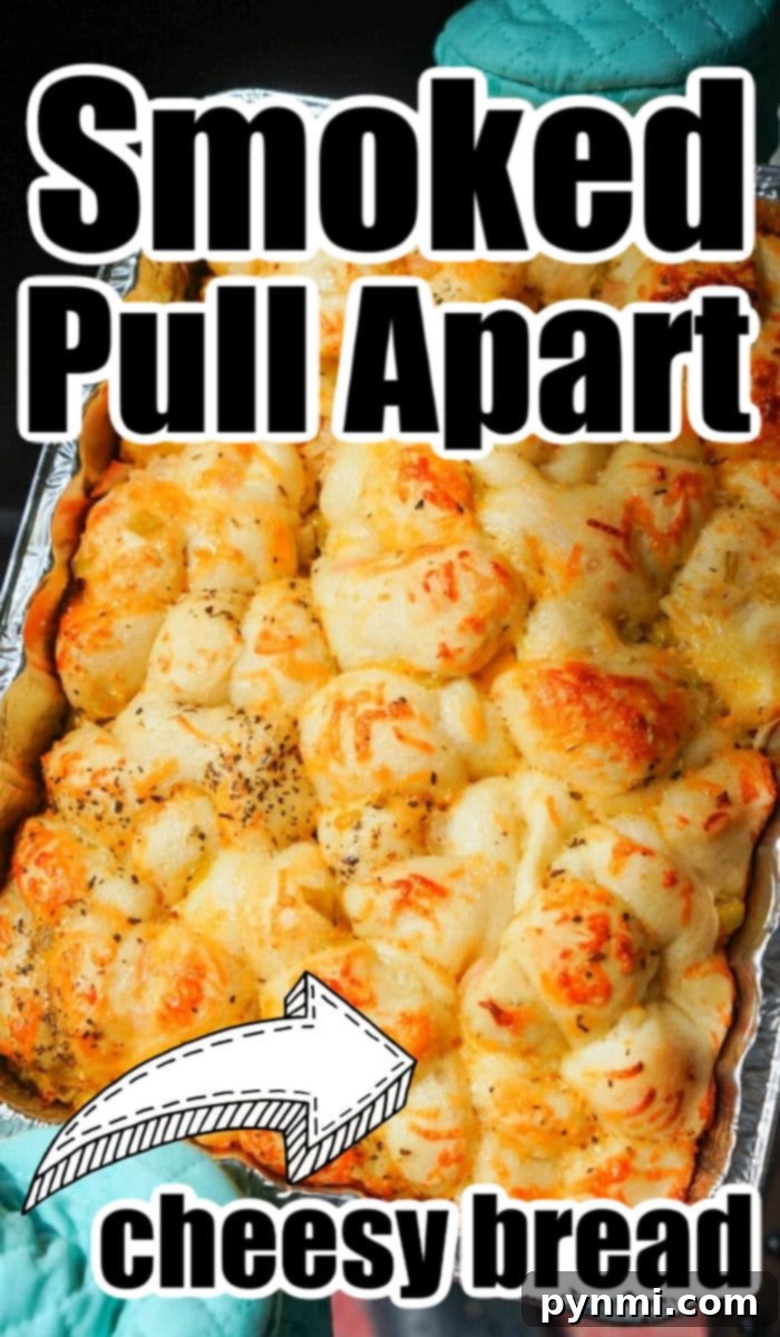 Smoked cheesy pull-apart bread baking inside a smoker, showing a golden crust.