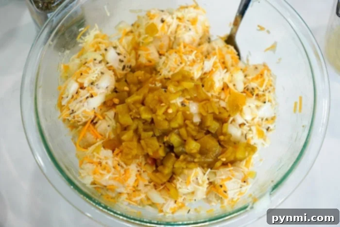 Diced Rhodes dinner rolls in a mixing bowl, ready to be coated with ingredients for pull-apart garlic bread.