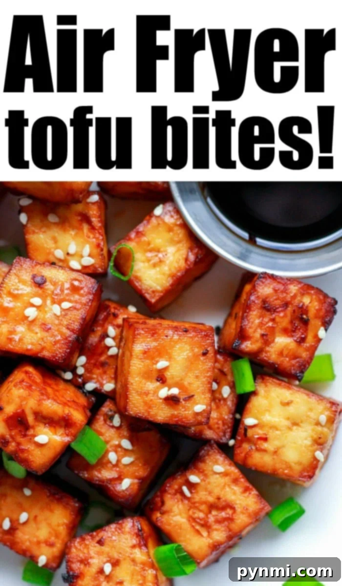 Crispy Air Fryer Tofu with Asian Marinade, garnished with sesame seeds and green onions