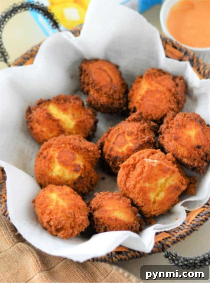 A vibrant bowl of crispy air fryer hushpuppies, garnished with fresh herbs, awaiting a delicious meal.