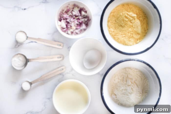 A spread of fresh hush puppy ingredients including cornmeal, flour, milk, eggs, and diced onions.