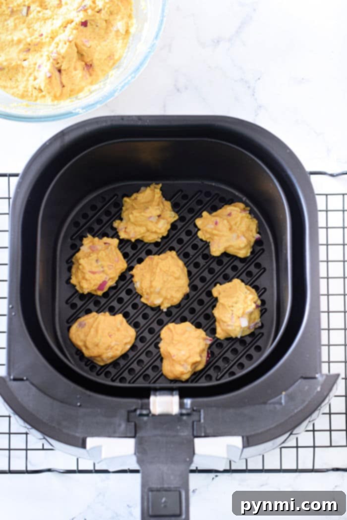A close-up shot of golden-brown air fryer hushpuppies, ready to be served.
