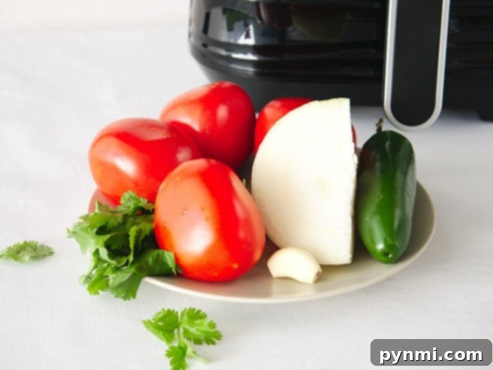 Flavor-Packed Air Fryer Tomatoes 4 Close-up of air fryer basket filled with ripe tomatoes, ready to be roasted to perfection.