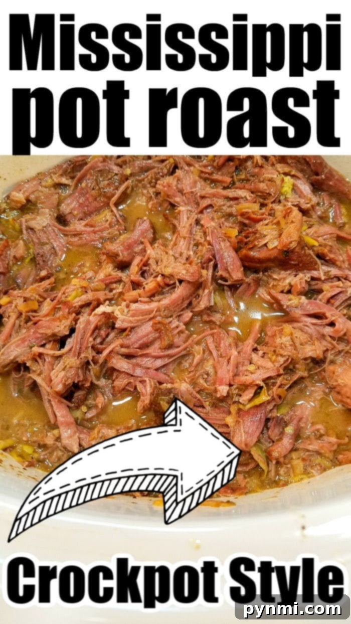 Shredded Mississippi Roast served over mashed potatoes.