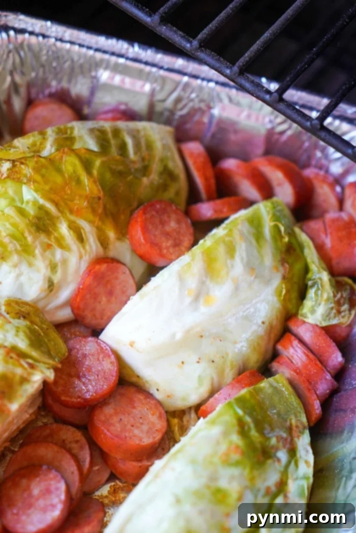 Delicious smoked sausage and cabbage ready to be served from a smoker, showing the beautiful char and tender texture