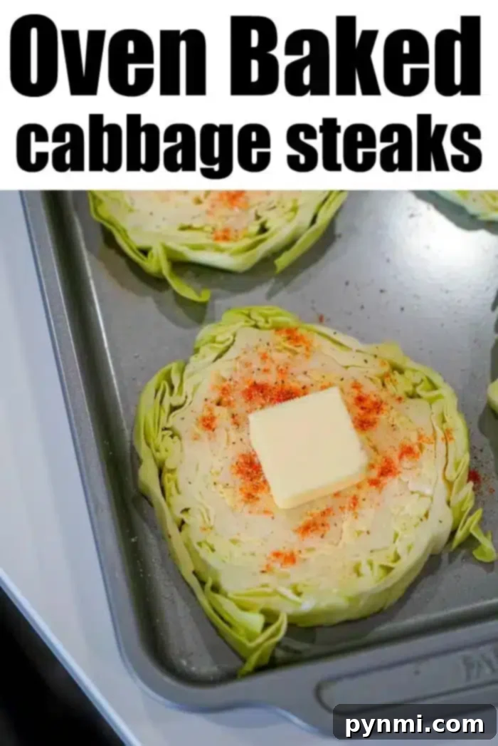 Hearty Cabbage Steaks 7 A close-up of baked cabbage steaks on a baking sheet, each topped with a pat of butter and sprinkled with seasoning. The text "Oven Baked Cabbage Steaks" is displayed at the top of the image.