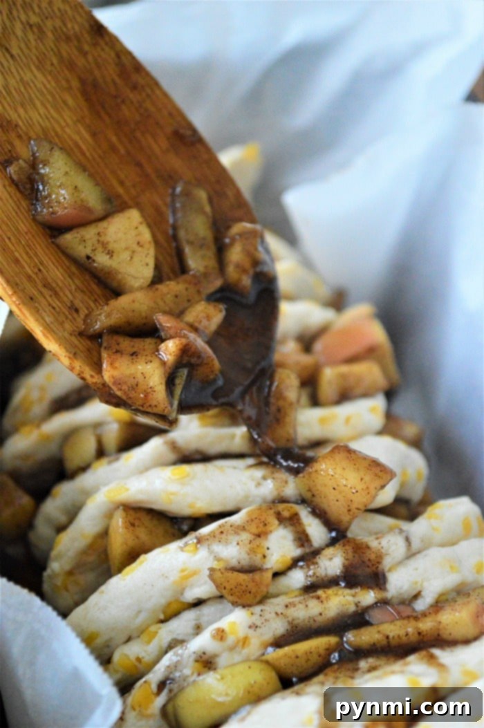 Easy apple cinnamon pull apart bread made with refrigerated biscuits is the best breakfast or dessert! Ooey gooey finger food with a slight caramel flavor. #pullapartbread #applebread #cinnamonbread #breakfast