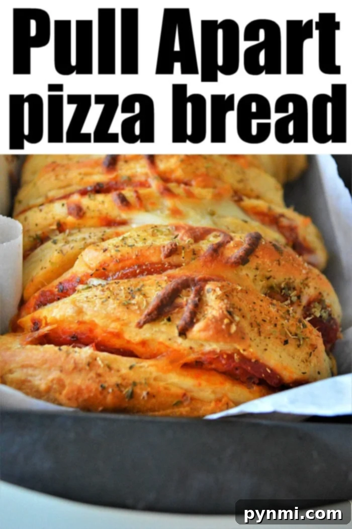 Ultimate Pizza Monkey Bread 7 Close-up of a single slice of pull apart pizza bread, showing the rich cheese and pepperoni filling, ready to eat