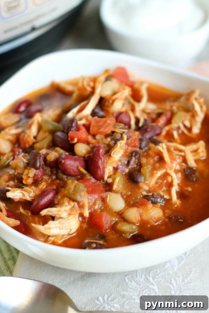 Hearty Instant Pot Chicken Chili 8 A large bowl of Instant Pot White Bean Chicken Chili, garnished and ready to serve.