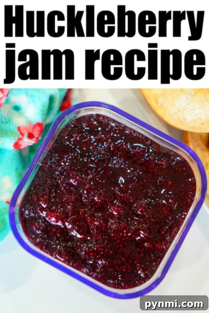 Huckleberry Delights 5 A jar of homemade berry jam with fresh huckleberries in the foreground, perfect for adding to cherished huckleberry recipes.