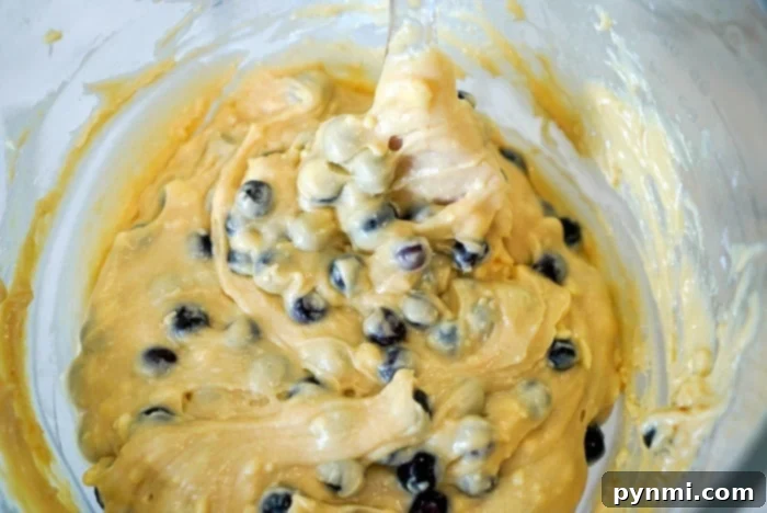 Several golden-brown muffins, possibly with berries, cooling on a rack, emphasizing the ease and deliciousness of this muffin recipe.