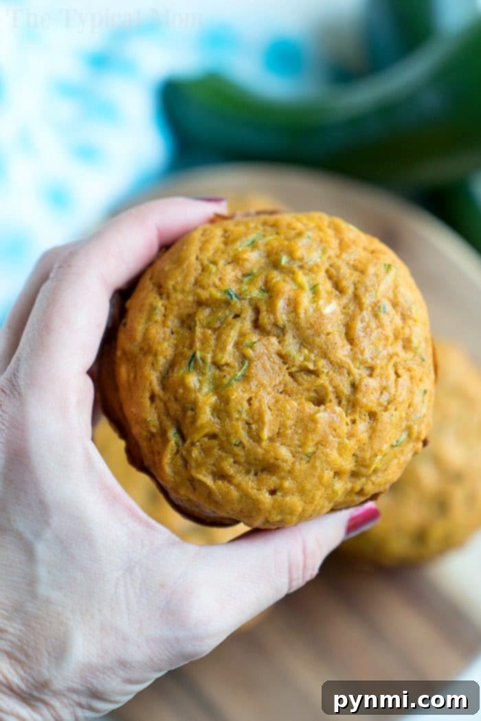 Pumpkin Zucchini Muffins with a crumbly topping, showcasing a delicious autumn-inspired muffin recipe.
