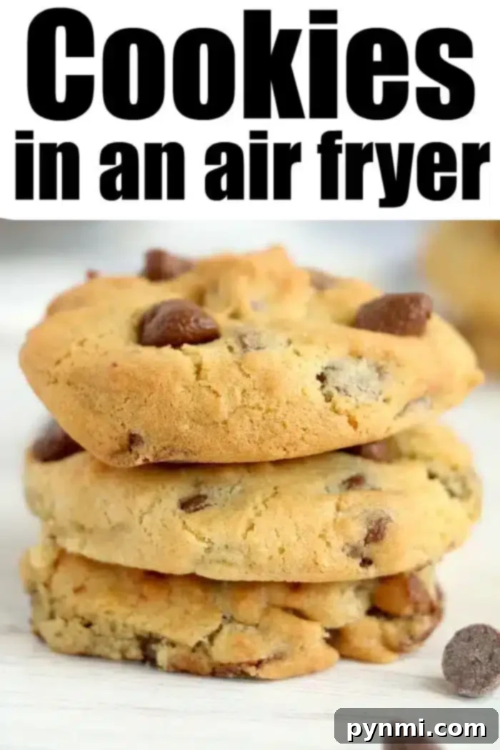 Air Fried Chocolate Chip Perfection 2 A stack of three golden brown chocolate chip air fryer cookies sits invitingly on a white surface, promising a delightful treat.