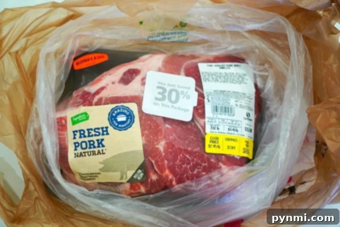 Pitmaster's Pulled Pork 4 Packaged fresh boneless pork, labeled Natural, nestled in a plastic bag with a 30% discount sticker—perfect for crafting your own smoked pulled pork on any Traeger grill.