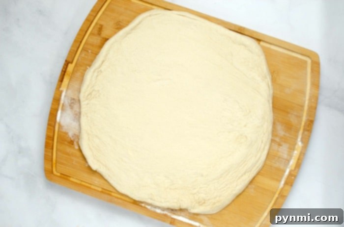 Fluffy Dough Every Time: Your Proofing Guide 5 Homemade pizza dough, stretched and topped, ready for the oven, a testament to effective dough proofing.