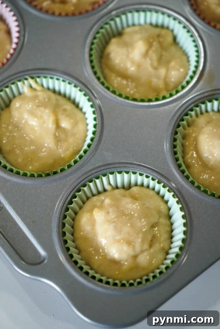 Mayonnaise Magic Banana Bread 7 A delectable spread of banana muffins, made with the special mayonnaise recipe, beautifully arranged on a wooden board with a cup of coffee and a fresh banana in the background, inviting a moment of pure enjoyment.