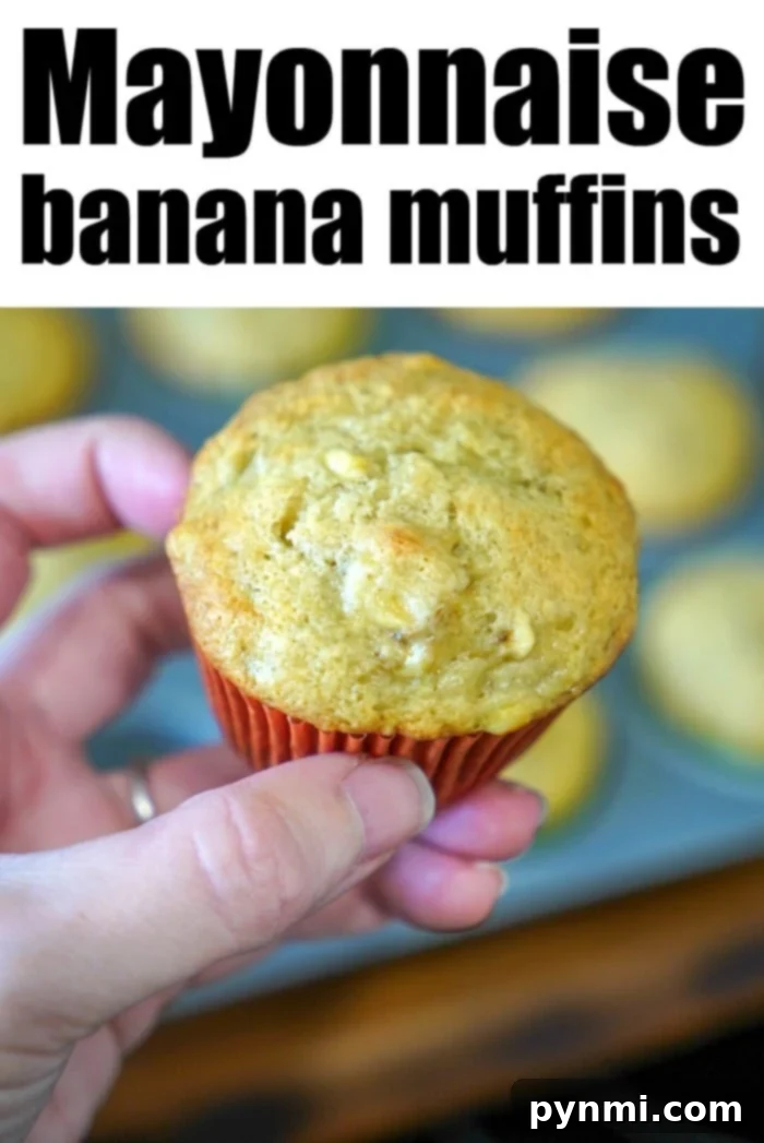 Mayonnaise Magic Banana Bread 8 Freshly baked banana muffins with mayonnaise, still in the muffin tin, cooling on a rack, ready to be enjoyed.