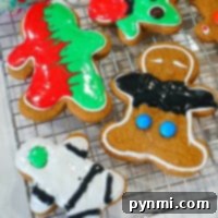 A festive gingerbread man cookie, made with cake mix, beautifully decorated with white icing and sprinkles.