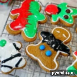 Cake Mix Hack for Air Fryer Gingerbread Cookies 8 A top-down shot of gingerbread cookies in an air fryer basket, with some cooling on a rack, emphasizing the ease of air fryer baking.