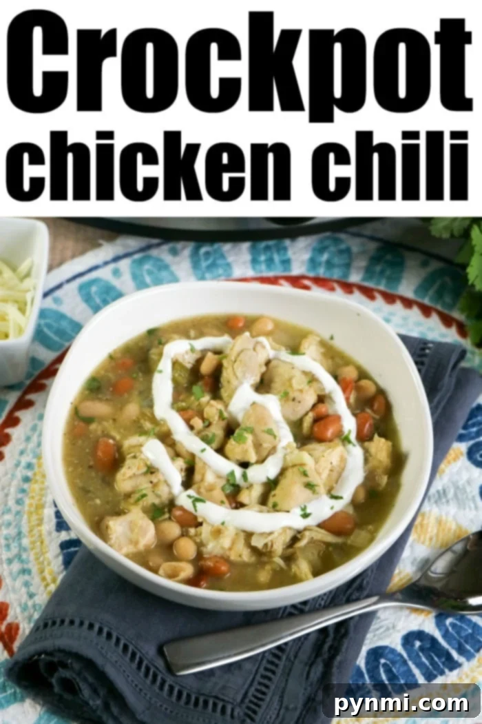 Creamy Crockpot White Chicken Chili 7 Easy White Chicken Chili Crockpot, garnished with fresh cilantro and a dollop of sour cream in a rustic bowl.