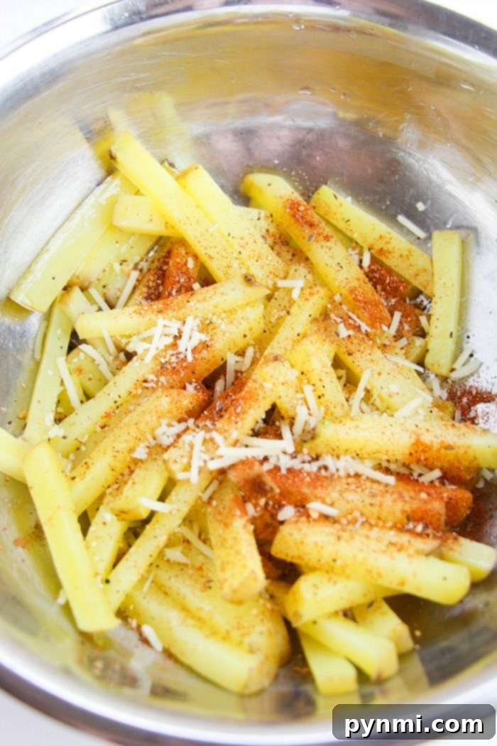 A close-up of a serving of homemade, oven-baked French fries, golden brown and crispy.