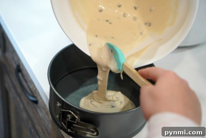 A single air fryer pancake, perfectly golden and thick, on a white plate with syrup and a fork.