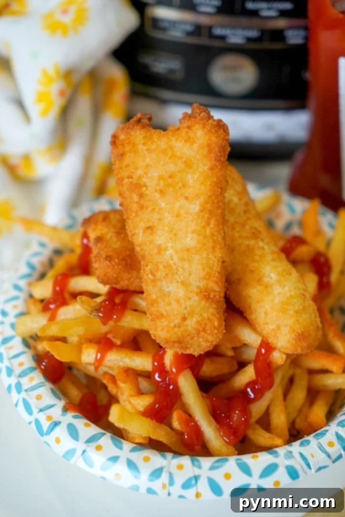 Crispy Air Fryer Fish and Chips 8 Delicious fish and chips cooking in an air fryer, with distinct layers for perfect crispiness.